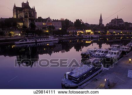 Stock Image -  France, Auxerre, Burgundy, Yonne, Bourgogne, Europe, wine region, Reflection of the Cathedral St. Etienne in the Yonne River in the evening in the city of Auxerre.. Fotosearch