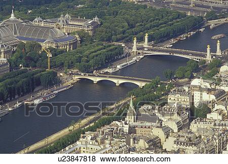 Stock Photo -  France, Paris, Ile de France, France, Aerial view of the city of Paris and the Grand Palais along the Seine River looking Northeast from the Eiffel Tower.. Fotosearch
