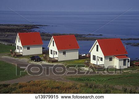 Gaspe Peninsula, Petit Vallee, Quebec, Canada, Gulf of St. Lawrence, Three white cabins with red roofs in the village of Petit Vallee on the Gaspe Peninsula along the St. Lawrence River in Quebec. View Large Photo Image Stock Photography - Gaspe Peninsula, Petit Vallee, Quebec, Canada, Gulf of St. Lawrence, Three white cabins with red roofs in the village of Petit Vallee on the Gaspe Peninsula along the St. Lawrence River in Quebec.. Fotosearch