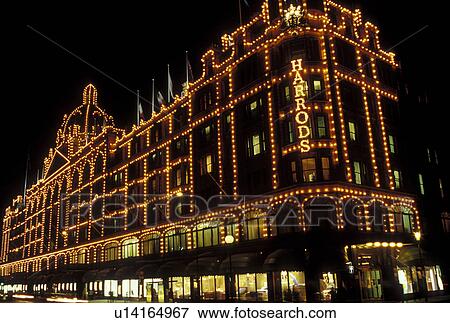 Stock Photo -  Harrods, London, England, Great Britain, United Kingdom, Europe, Harrods Department Store illuminated at night in downtown London.. Fotosearch