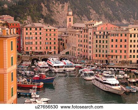 Stock Image -  Italy, Camogli, Riviera di Levante, Liguria, Ligurian Riviera, Europe, Scenic view of the fishing port in the resort town of Camogli along the Ligurian Sea.. Fotosearch