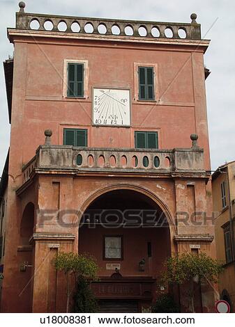 Stock Image -  Italy, Lazio, Tuscania, Europe, Sundial on the side of a building in the village of Tuscania.. Fotosearch