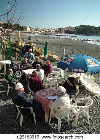 Italy, Liguria, Sestri Levante, Riviera di Levante, Ligurian Riviera, Europe, Men playing cards along the waterfront in Sestri Levante along the Ligurian Sea. View Large Photo Image Stock Photograph - Italy, Liguria, Sestri Levante, Riviera di Levante, Ligurian Riviera, Europe, Men playing cards along the waterfront in Sestri Levante along the Ligurian Sea.. Fotosearch