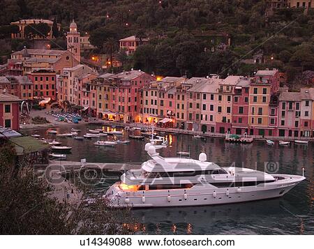 Stock Photo -  Italy, Portofino, Liguria, Riviera di Levante, Ligurian Riviera, Europe, Scenic view of the harbor of the resort town of Portofino in the evening along the Ligurian Sea.. Fotosearch