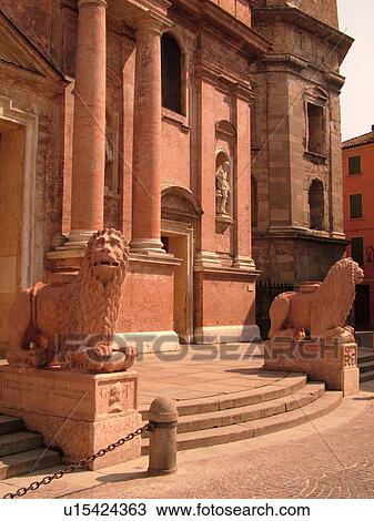 Stock Image -  Italy, Reggio nell'Emilia, Emilia-Romagna, Europe, 15th-century Chiesa di San Prospero guarded by red marble lion statues in the town of Reggio Emilia.. Fotosearch