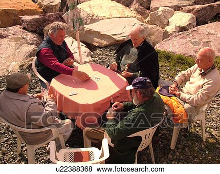 Italy, Sestri Levante, Liguria, Riviera di Levante, Ligurian Riviera, Europe, Senior Italian men playing cards at a table along the beach in the resort town of Sestri Levante on the Ligurian Sea. View Large Photo Image Stock Photo - Italy, Sestri Levante, Liguria, Riviera di Levante, Ligurian Riviera, Europe, Senior Italian men playing cards at a table along the beach in the resort town of Sestri Levante on the Ligurian Sea.. Fotosearch