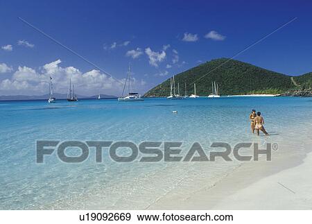 Jost Van Dyke, beach, British Virgin Islands, Caribbean, BVI, Two women talking in the water at the beach on White Bay on Jost Van Dyke Island on the Caribbean Sea. View Large Photo Image Stock Photo - Jost Van Dyke, beach, British Virgin Islands, Caribbean, BVI, Two women talking in the water at the beach on White Bay on Jost Van Dyke Island on the Caribbean Sea.. Fotosearch
