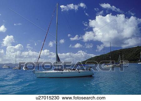Stock Image -  Jost Van Dyke, British Virgin Islands, Caribbean, BVI, Sailboats anchored in Great Harbor off of Jost Van Dyke Island on the Caribbean Sea.. Fotosearch