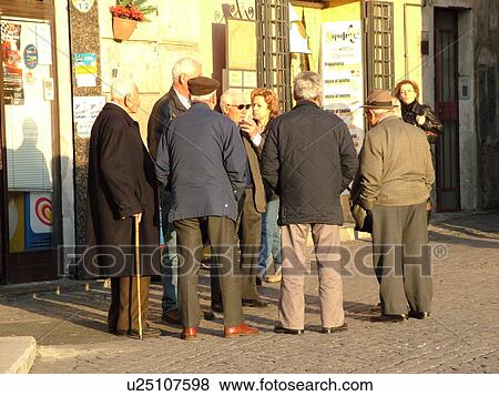 Lazio, Italy, Tarquinia, Europe, Local Italian men talking together in the medieval centre of Tarquinia. View Large Photo Image Stock Photo - Lazio, Italy, Tarquinia, Europe, Local Italian men talking together in the medieval centre of Tarquinia.. Fotosearch