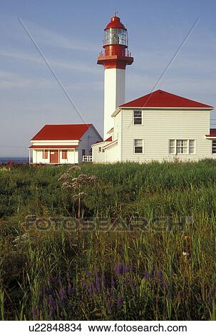 Picture -  lighthouse, Gaspe Peninsula, Quebec, Metis-sur-Mer, Canada, Gulf of St. Lawrence, Pointe-de-Mitis Lighthouse with red roof in Metis-Sur-Mer along the St. Lawrence River on the Gaspe Peninsula in Quebec.. Fotosearch
