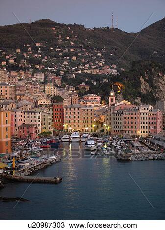 Stock Image -  Liguria, Italy, Camogli, Riviera di Levante, Ligurian Riviera, Europe, Scenic view of the fishing port in the resort town of Camogli at sunset along the Ligurian Sea.. Fotosearch