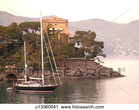 Stock Image -  Liguria, Italy, Paraggi, Riviera di Levante, Ligurian Riviera, Europe, Sailboat anchored in the bay at Paraggi on the Ligurian Sea.. Fotosearch