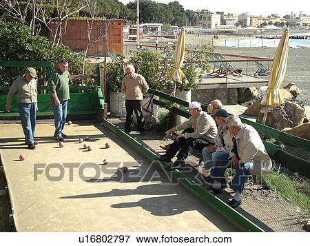 Liguria, Italy, Sestri Levante, Riviera di Levante, Ligurian Riviera, Europe, Men playing the game of Bocce on the waterfront in Sestri Levante along the Ligurian Sea. View Large Photo Image Stock Photo -  Liguria, Italy, Sestri Levante, Riviera di Levante, Ligurian Riviera, Europe, Men playing the game of Bocce on the waterfront in Sestri Levante along the Ligurian Sea.. Fotosearch
