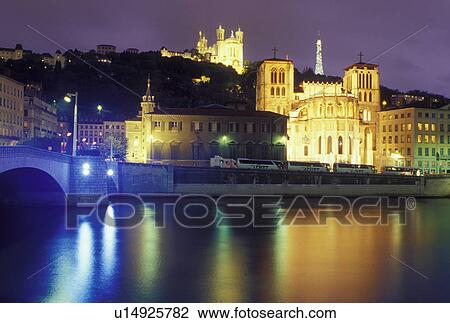 Lyon, France, Rhone-Alpes, Europe, Cathedral Saint Jean (below) and Basilique Notre Dame de Fourviere (above) illuminated at night along the Saone River in Lyon. View Large Photo Image Stock Image - Lyon, France, Rhone-Alpes, Europe, Cathedral Saint Jean (below) and Basilique Notre Dame de Fourviere (above) illuminated at night along the Saone River in Lyon.. Fotosearch