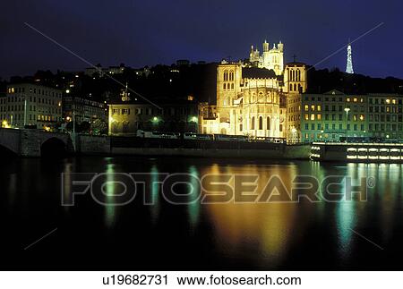 Lyon, France, Rhone-Alpes, Europe, Cathedral Saint Jean (below) and Basilique Notre Dame de Fourviere (above) illuminated at night along the Saone River in Lyon. View Large Photo Image Stock Image - Lyon, France, Rhone-Alpes, Europe, Cathedral Saint Jean (below) and Basilique Notre Dame de Fourviere (above) illuminated at night along the Saone River in Lyon.. Fotosearch