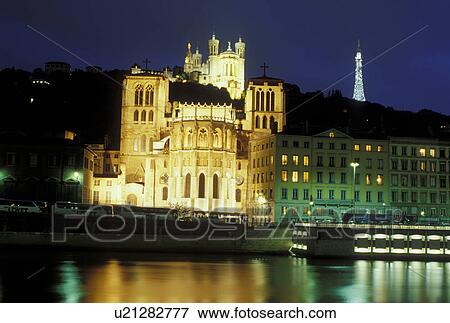 Lyon, Rhone-Alpes, France, Europe, Cathedral Saint Jean (below) and Basilique Notre Dame de Fourviere (above) illuminated at night along the Saone River in Lyon. View Large Photo Image Stock Photo - Lyon, Rhone-Alpes, France, Europe, Cathedral Saint Jean (below) and Basilique Notre Dame de Fourviere (above) illuminated at night along the Saone River in Lyon.. Fotosearch