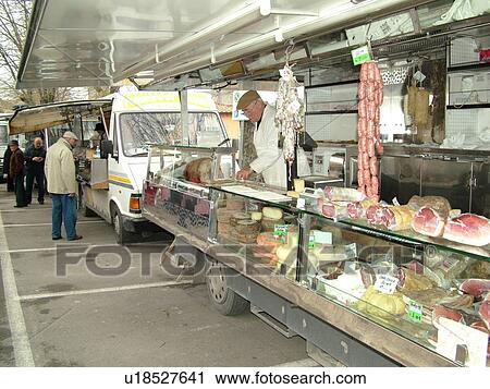 Stock Image -  market day, Italy, Tuscany, Montalcino, Toscana, Europe, Italian meats and cheeses for sale at the outdoor market in the town of Montalcino.. Fotosearch