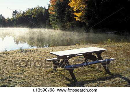 Stock Photo -  ME, Maine, Baxter State Park, Picnic table on Abol Beach along Abol Pond in Baxter State Park in the fall. . Fotosearch