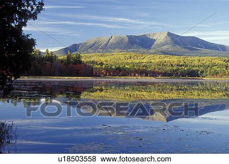 Stock Photo -  ME, Maine, Baxter State Park, Scenic view of Mt. Katahdin reflecting in the calm waters of Compass Pond in Baxter State Park in the fall. . Fotosearch