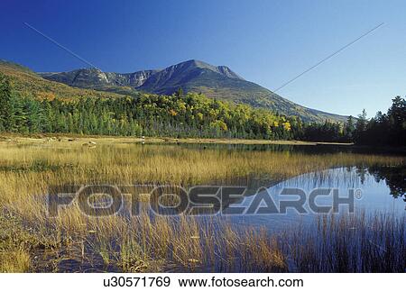 Stock Photo -  ME, Maine, Baxter State Park, Scenic view of Mt. Katahdin from Tracy Pond in Baxter State Park in the fall. . Fotosearch
