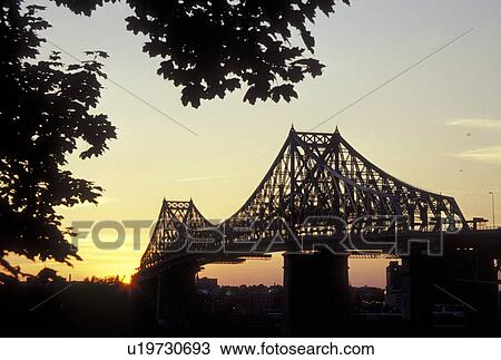 Stock Image -  Montreal, Canada, Quebec, Pont Jacques Cartier (Jacques Cartier Bridge) at sunset crossing the St. Lawrence River (Fleuve Saint-Laurent) in Montreal.. Fotosearch