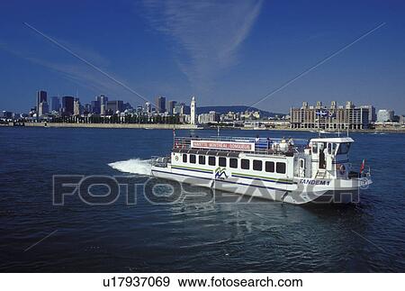 Montreal, Canada, Quebec, Sightseeing tourboat cruises along the St. Lawrence River (Fleuve Saint-Laurent) with a view of the Montreal skyline. View Large Photo Image Stock Photo - Montreal, Canada, Quebec, Sightseeing tourboat cruises along the St. Lawrence River (Fleuve Saint-Laurent) with a view of the Montreal skyline.. Fotosearch
