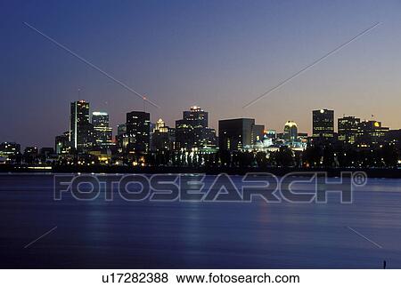 Montreal, Canada, Quebec, Skyline of downtown Montreal along the St. Lawrence River (Fleuve Saint-Laurent) in the evening. View Large Photo Image Stock Photo - Montreal, Canada, Quebec, Skyline of downtown Montreal along the St. Lawrence River (Fleuve Saint-Laurent) in the evening.. Fotosearch