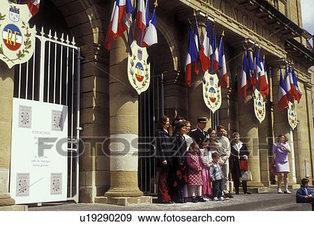 Stock Photo -  Moulins, Auvergne, France, Allier, Europe, Wedding party poses outside the Hotel de Ville in the city of Moulins.. Fotosearch
