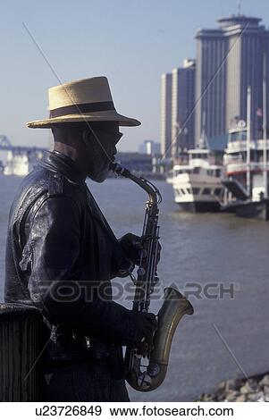 New Orleans, LA, Louisiana, Mississippi River, Street musician playing a saxophone along Moonwalk View Large Photo Image Stock Photo - New Orleans, LA, Louisiana, Mississippi River, Street musician playing a saxophone along Moonwalk. Fotosearch