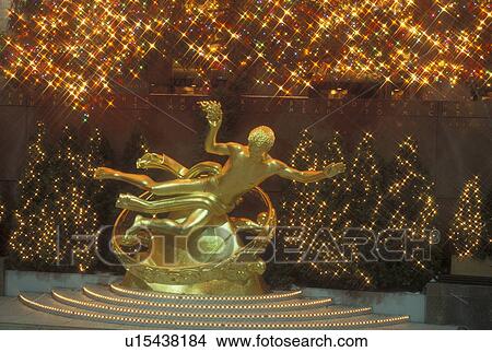 Picture -  New York City, NY, New York, downtown, Rockefeller Plaza, Christmas lights, evening, statue. Fotosearch