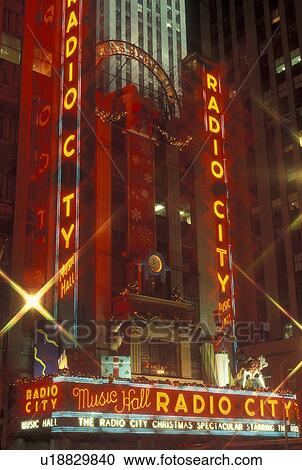 Stock Image -  New York City, NY, New York, downtown, Radio City Music Hall, Christmas Spectacular, neon lights, evening. Fotosearch