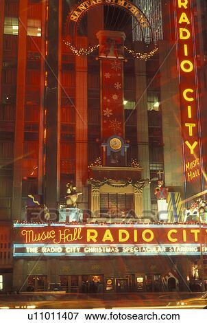 Stock Photo -  New York City, NY, New York, downtown, Radio City Music Hall, Christmas Spectacular, neon lights, evening. Fotosearch