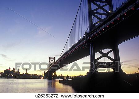 Stock Image -  PA, Philadelphia, Pennsylvania, Ben Franklin Bridge, Delaware River, evening. Fotosearch