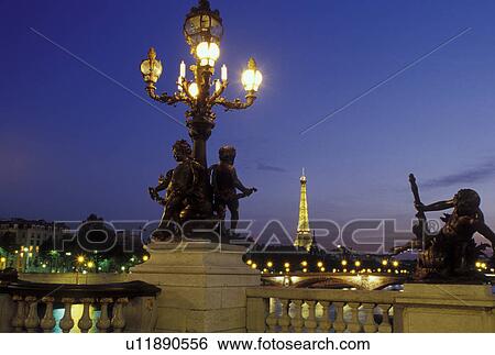 Stock Photograph -  Paris, Ile de France, France, Europe, Ponte de la Concorde and Eiffel Tower along the Seine River in the city of Paris in the evening.. Fotosearch