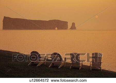 Perce, Gaspe Peninsula, Quebec, Canada, Ile Bonaventure and Perce Rock National Park, Gulf of St. Lawrence, Scenic view of Rocher Perce (Perce Rock) at sunrise on the Gulf of St. Lawrence in Perce on Gaspe Peninsula in Quebec. View Large Photo Image Stock Image -  Perce, Gaspe Peninsula, Quebec, Canada, Ile Bonaventure and Perce Rock National Park, Gulf of St. Lawrence, Scenic view of Rocher Perce (Perce Rock) at sunrise on the Gulf of St. Lawrence in Perce on Gaspe Peninsula in Quebec.. Fotosearch