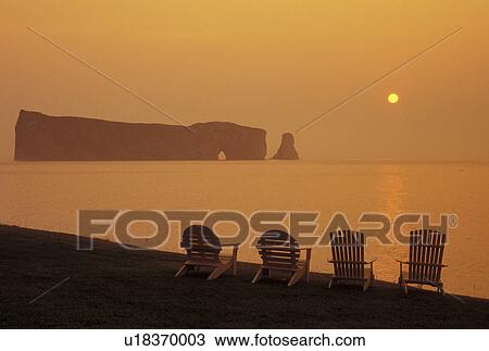 Perce, Gaspe Peninsula, Quebec, Canada, Ile Bonaventure and Perce Rock National Park, Gulf of St. Lawrence, Scenic view of Rocher Perce (Perce Rock) at sunrise on the Gulf of St. Lawrence in Perce on Gaspe Peninsula in Quebec. View Large Photo Image Stock Image - Perce, Gaspe Peninsula, Quebec, Canada, Ile Bonaventure and Perce Rock National Park, Gulf of St. Lawrence, Scenic view of Rocher Perce (Perce Rock) at sunrise on the Gulf of St. Lawrence in Perce on Gaspe Peninsula in Quebec.. Fotosearch