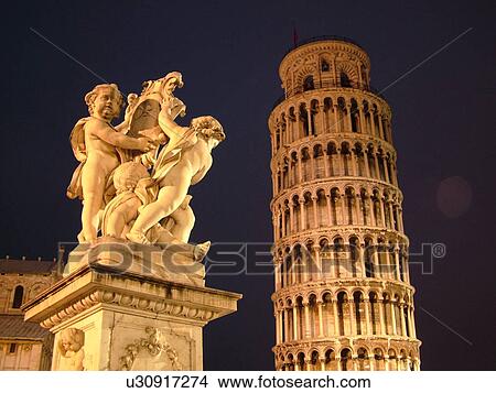 Picture -  Pisa, Italy, Tuscany, Toscana, Europe, Cupid Statue outside the Leaning Tower of Pisa (Torre Pendente) in Campo dei Miracoli (Field of Miracles) in the evening in the city of Pisa.. Fotosearch