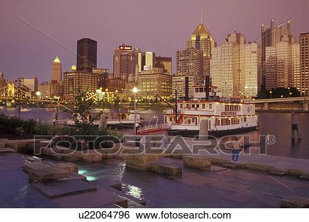 Stock Photograph -  Pittsburgh, PA, Pennsylvania, downtown, skyline, Allegheny River, evening, riverboats, riverfront park. Fotosearch