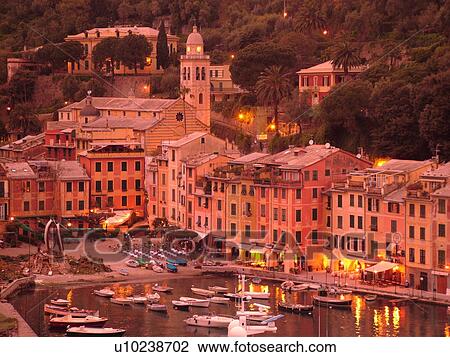 Stock Image -  Portofino, Italy, Riviera di Levante, Ligurian Riviera, Liguria, Europe, Scenic view of the harbor of the resort town of Portofino in the evening along the Ligurian Sea.. Fotosearch