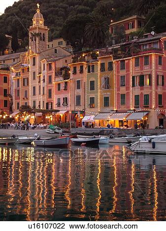 Stock Image -  Portofino, Italy, Riviera di Levante, Liguria, Ligurian Riviera, Europe, Boats in the harbor of the resort town of Portofino in the evening along the Ligurian Sea.. Fotosearch