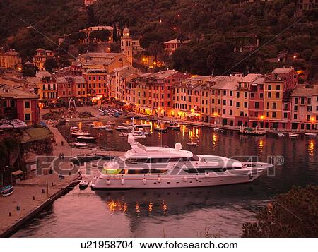 Portofino, Liguria, Italy, Riviera di Levante, Ligurian Riviera, Europe, Scenic view of the harbor of the resort town of Portofino in the evening along the Ligurian Sea. View Large Photo Image Picture - Portofino, Liguria, Italy, Riviera di Levante, Ligurian Riviera, Europe, Scenic view of the harbor of the resort town of Portofino in the evening along the Ligurian Sea.. Fotosearch