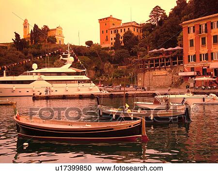 Stock Image -  Portofino, Liguria, Italy, Riviera di Levante, Ligurian Riviera, Europe, Fishing boats in the harbor of the resort town of Portofino along the Ligurian Sea.. Fotosearch
