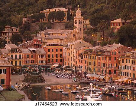 Stock Image -  Portofino, Liguria, Italy, Riviera di Levante, Ligurian Riviera, Europe, Scenic view of the harbor and resort town of Portofino in the evening along the Ligurian Sea.. Fotosearch