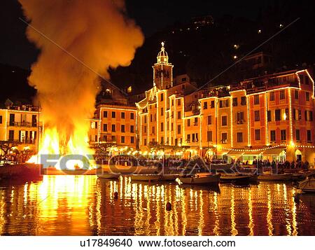 Portofino, Liguria, Italy, Riviera di Levante, Ligurian Riviera, Europe, A large bonfire burns in the portside square at night celebrating St. George Feast Day (April 23) in the resort town of Portofino along the Ligurian Sea. View Large Photo Image Stock Image - Portofino, Liguria, Italy, Riviera di Levante, Ligurian Riviera, Europe, A large bonfire burns in the portside square at night celebrating St. George Feast Day (April 23) in the resort town of Portofino along the Ligurian Sea.. Fotosearch
