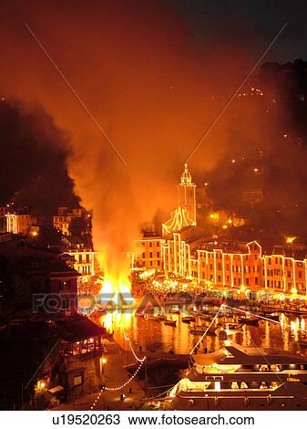 Portofino, Liguria, Italy, Riviera di Levante, Ligurian Riviera, Europe, A large bonfire burns in the portside square at night celebrating St. George Feast Day (April 23) in the resort town of Portofino along the Ligurian Sea. View Large Photo Image Stock Image - Portofino, Liguria, Italy, Riviera di Levante, Ligurian Riviera, Europe, A large bonfire burns in the portside square at night celebrating St. George Feast Day (April 23) in the resort town of Portofino along the Ligurian Sea.. Fotosearch