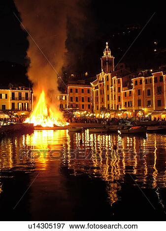 Stock Photo -  Portofino, Liguria, Italy, Riviera di Levante, Ligurian Riviera, Europe, A large bonfire burns in the portside square at night celebrating St. George Feast Day (April 23) in the resort town of Portofino along the Ligurian Sea.. Fotosearch