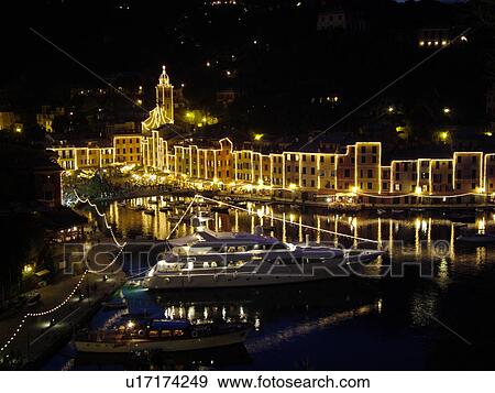 Stock Photo -  Portofino, Liguria, Italy, Riviera di Levante, Ligurian Riviera, Europe, Scenic view of the buildings illuminated at night along the waterfront of the resort town of Portofino on the Ligurian Sea.. Fotosearch