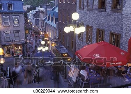 Quebec City, Canada, Quebec, Outdoor cafT with red umbrella at Quartier Petit-Champlain in the evening in Vieux Quebec (Old Quebec). View Large Photo Image Picture - Quebec City, Canada, Quebec, Outdoor cafT with red umbrella at Quartier Petit-Champlain in the evening in Vieux Quebec (Old Quebec).. Fotosearch