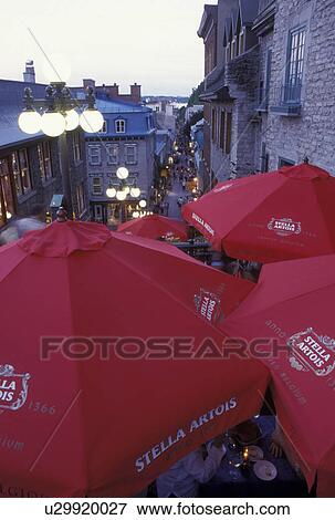 Quebec City, Canada, Quebec, Outdoor cafT with red umbrellas at Quartier Petit-Champlain in the evening in Vieux Quebec (Old Quebec). View Large Photo Image Stock Photo - Quebec City, Canada, Quebec, Outdoor cafT with red umbrellas at Quartier Petit-Champlain in the evening in Vieux Quebec (Old Quebec).. Fotosearch
