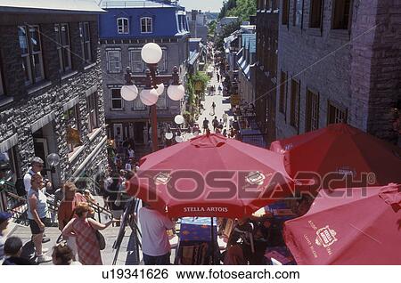 Stock Photograph -  Quebec City, Canada, Quebec, Outdoor cafT with red umbrellas at Quartier Petit-Champlain in Vieux Quebec (Old Quebec).. Fotosearch